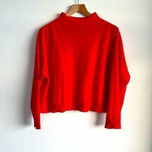 Orange Alani cashmere mock turtleneck sweater. Anthropologie’s brand Pilcro.